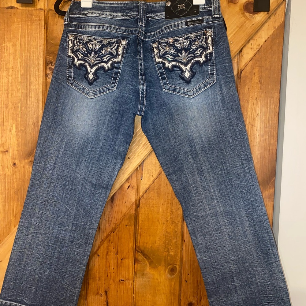 Miss Me Denim cropped jeans with gem embellished and embroidered pockets.